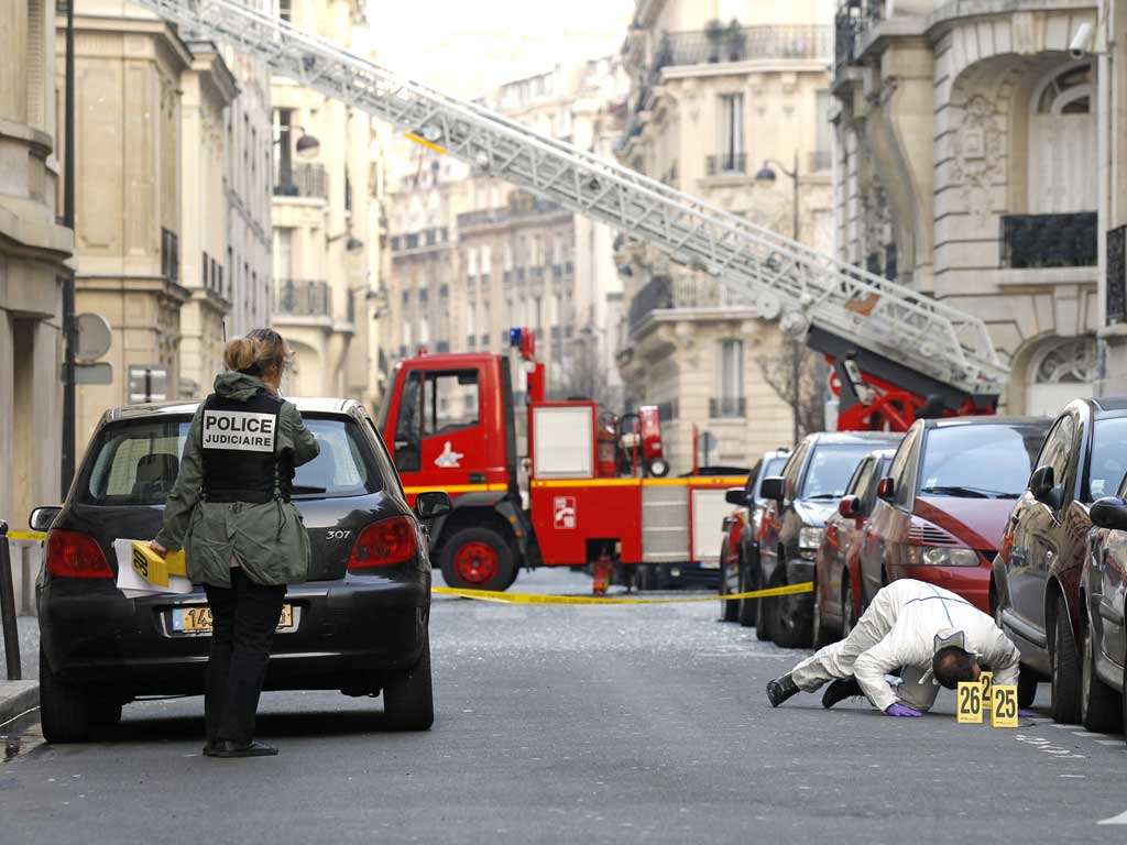 Police search the scene near the Indonesian embassy in Paris