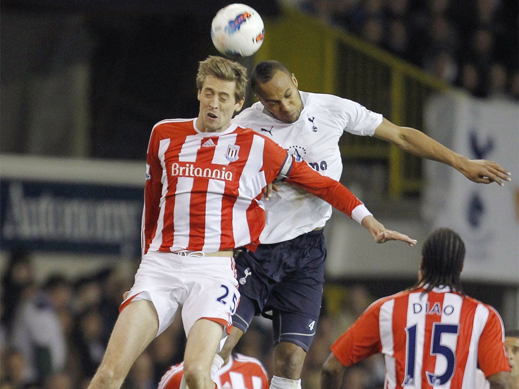 Spurs' Peter Crouch and Stoke's Younes Kaboul compete to win a header