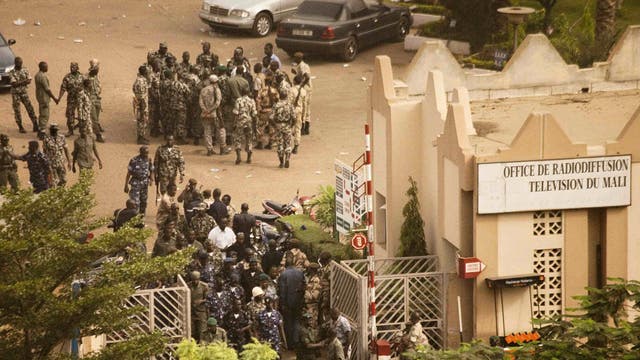 Malian soldiers and security forces gather at the offices of the state radio and television broadcaster after announcing a coup d'etat