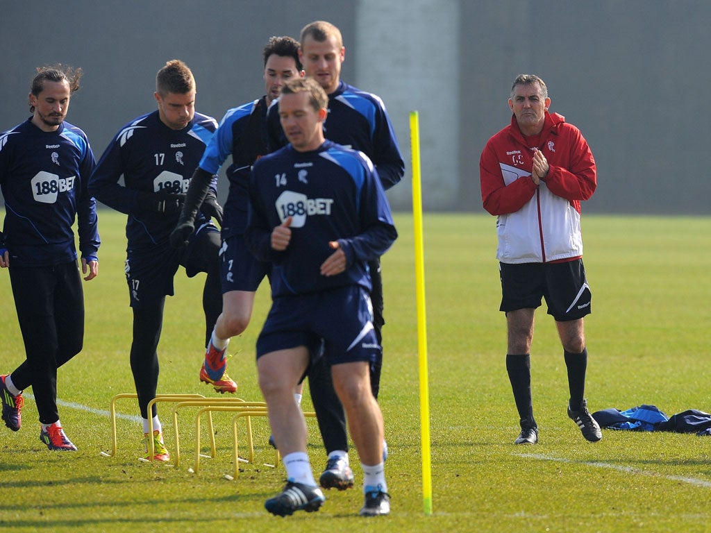 Owen Coyle (right) looks on as the Bolton players train yesterday