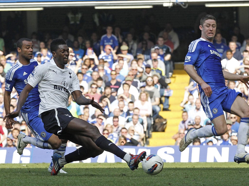 Gary Cahill defends a shot from Tottenham striker Emmanuel Adebayor