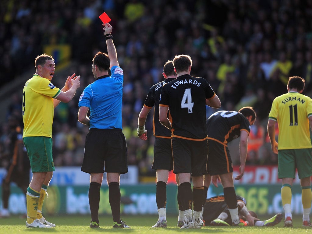 Norwich captain Grant Holt is shown the red card