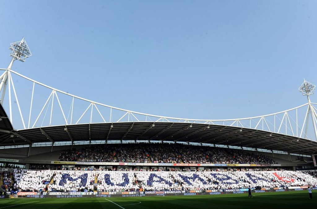 Fans hold up a tribute to Fabrice Muamba