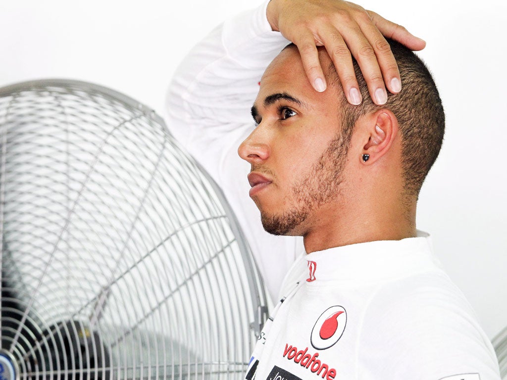 Breath of fresh air: Lewis Hamilton cools off after securing his second pole position of the new season, in Malaysia