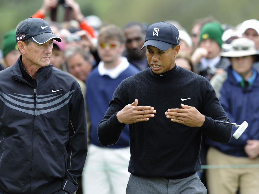 I'm all ears: Hank Haney, then Tiger Woods' coach, listens intently to his charge during the 2009 US Masters at Augusta. He has since written about Woods' private life