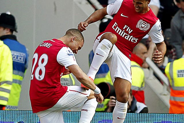 Knees up: Kieran Gibbs bows to Theo Walcott, another of Arsenal's goalscorers