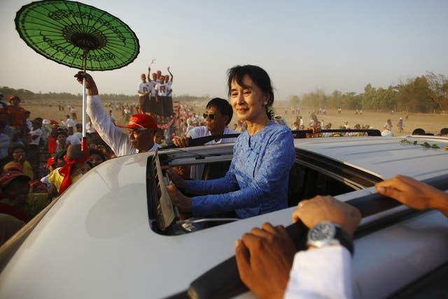 Aung San Suu Kyi greets supporters in Kawhmu township as Burma prepares to hold 48 by-elections