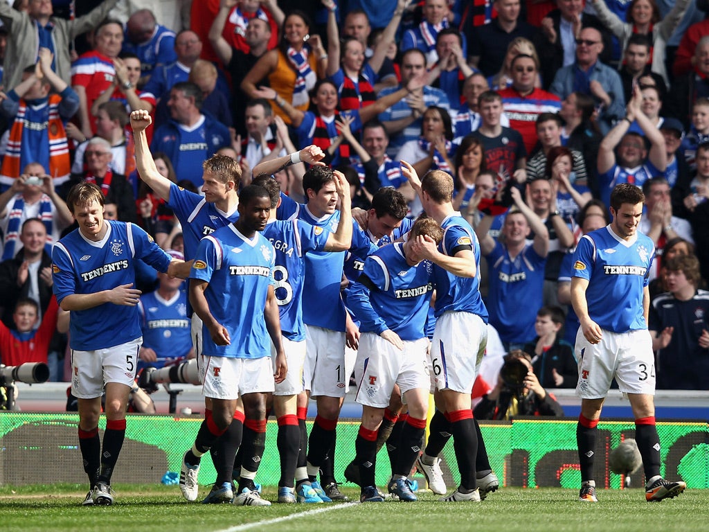 Lee Wallace of Rangers celebrates with team-mates after scoring his team's third goal
