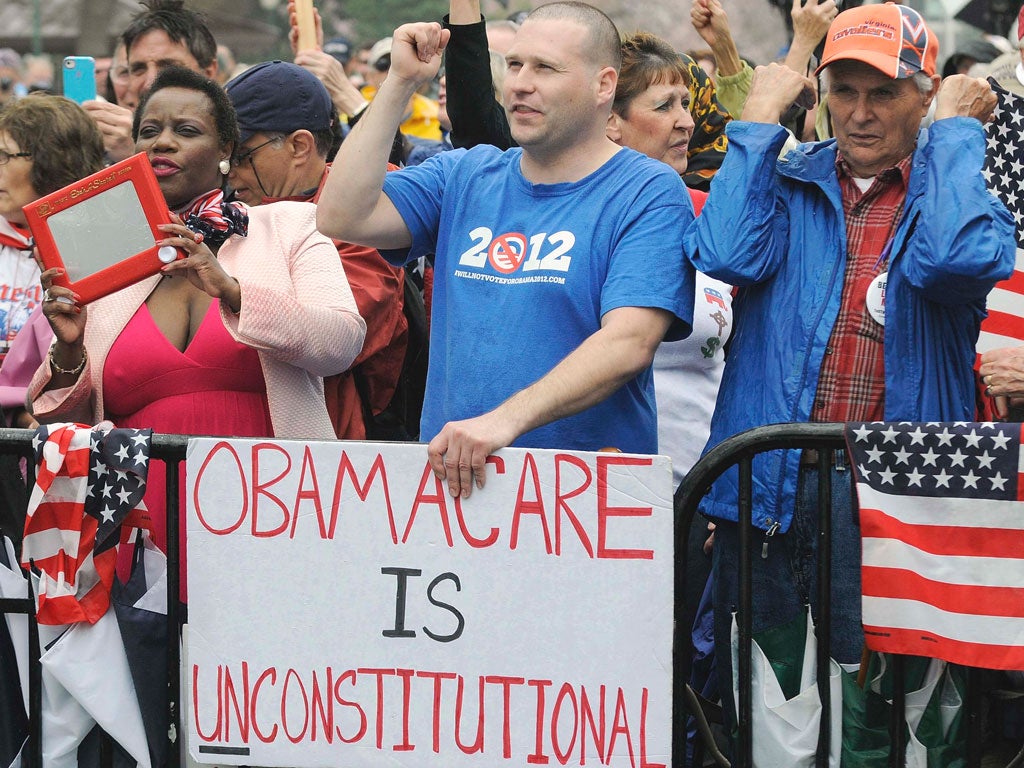 Protesters in Washington call for the repeal of the 2010 healthcare law championed by President Barack Obama, ahead of today’s
Supreme Court hearings