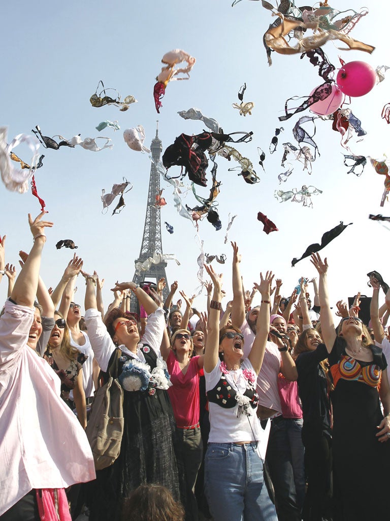 Women throw their bras in Paris supporting a breast cancer campaign