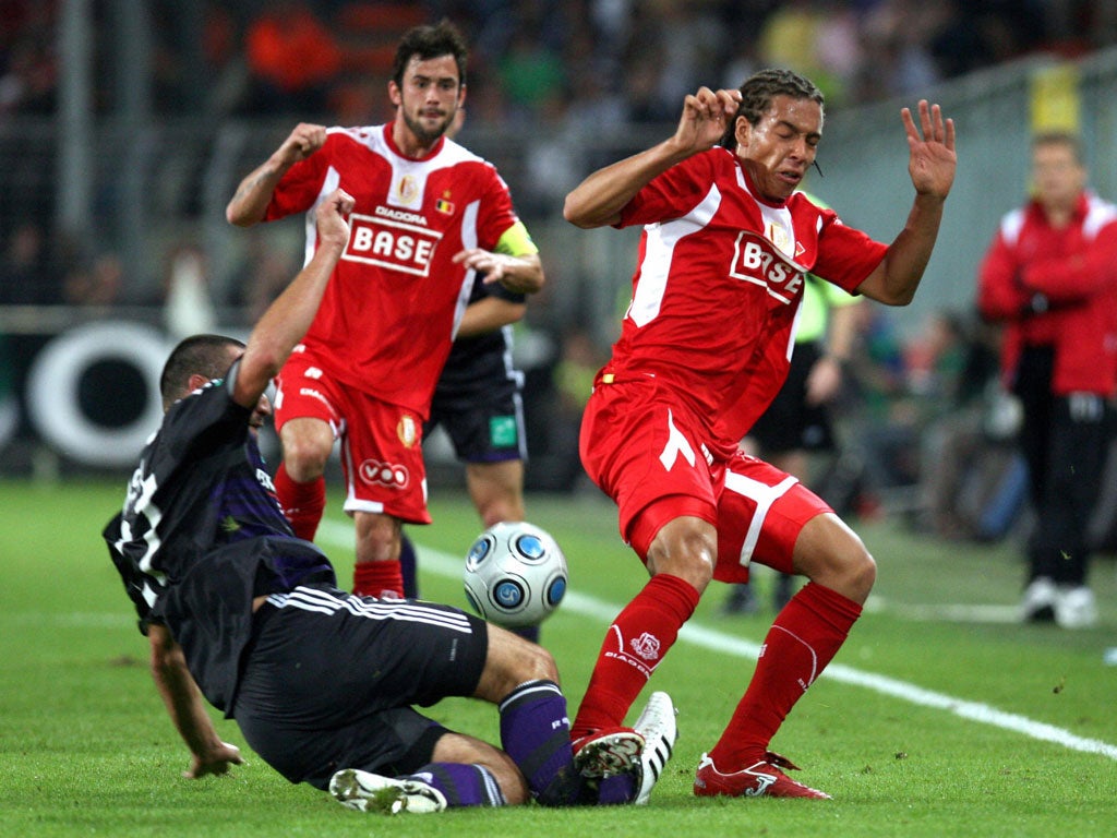 Axel Witsel tackles Marcin Wasilewski, of Anderlecht, in August 2009