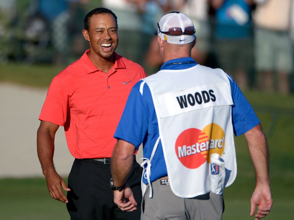 Tiger Woods celebrates with caddie Joe La Cava