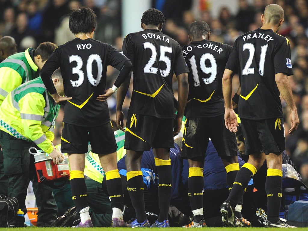 Bolton players look on as their stricken team-mate Fabrice Muamba is treated at White Hart Lane earlier this month