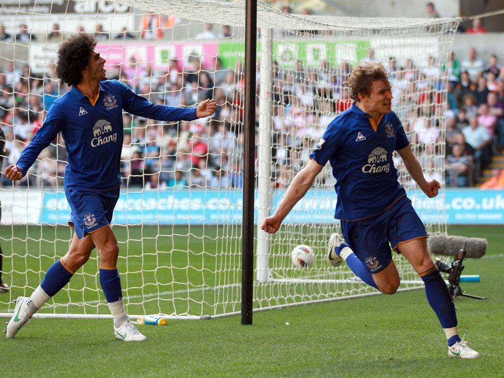 Swansea 0-2 Everton January signing Nikica Jelavic celebrates with Marouane Fellaini after scoring the goal that sealed victory for the Toffees and ended Swansea’s run of three consecutive victories.