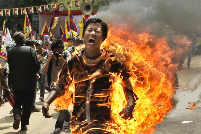 A Tibetan man set himself on fire and ran shouting through a demonstration in New Delhi yesterday