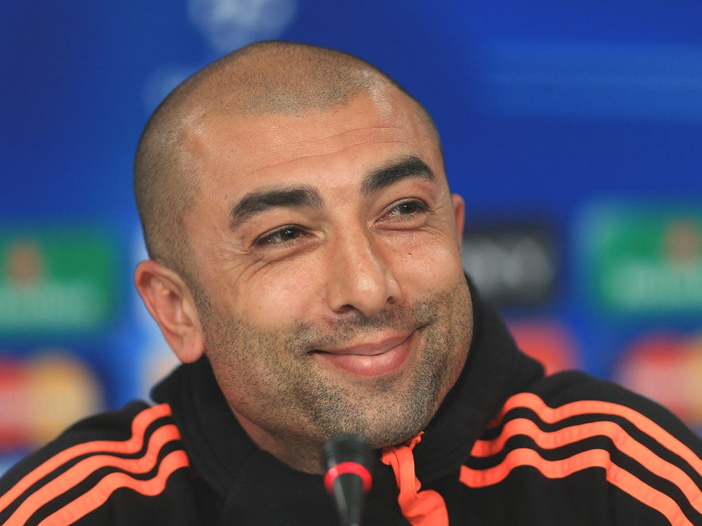 Roberto Di Matteo smiles as he listens to questions during a press conference in Lisbon yesterday
