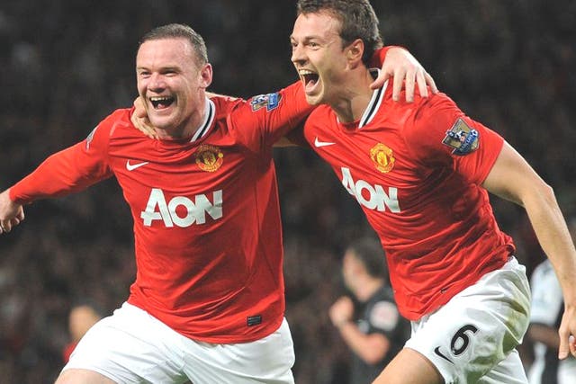 Wayne Rooney celebrates scoring the winner at Old Trafford with United team-mate Jonny Evans