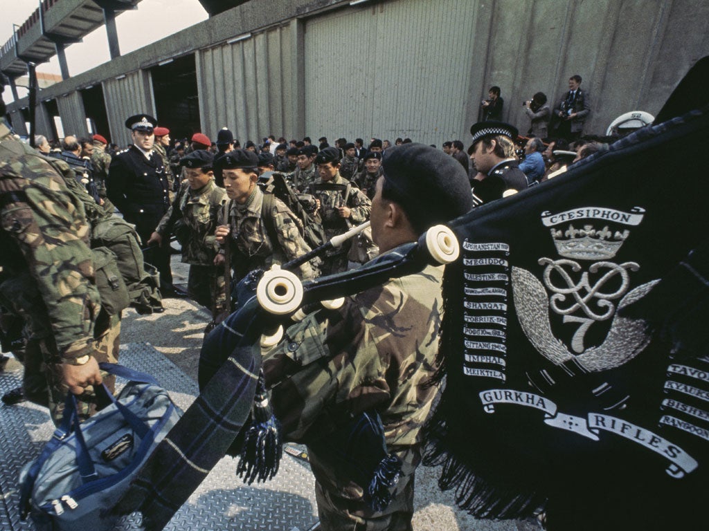 A piper plays as members of the Gurkha Rifles board the QE2 at Southampton