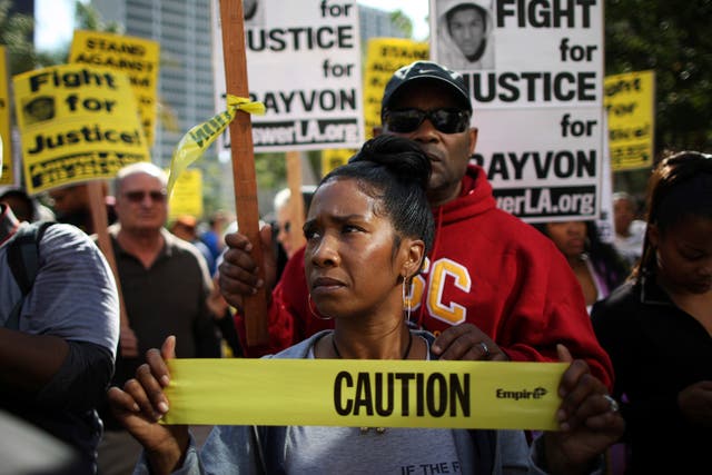 Trina Harrison and her husband, Rick Harrison, participate in a rally preceding a Million Hoodies March to protest the failure of police to arrest a Florida neighborhood watch volunteer for shooting to death an unarmed black teenager, Trayvon Martin, in L
