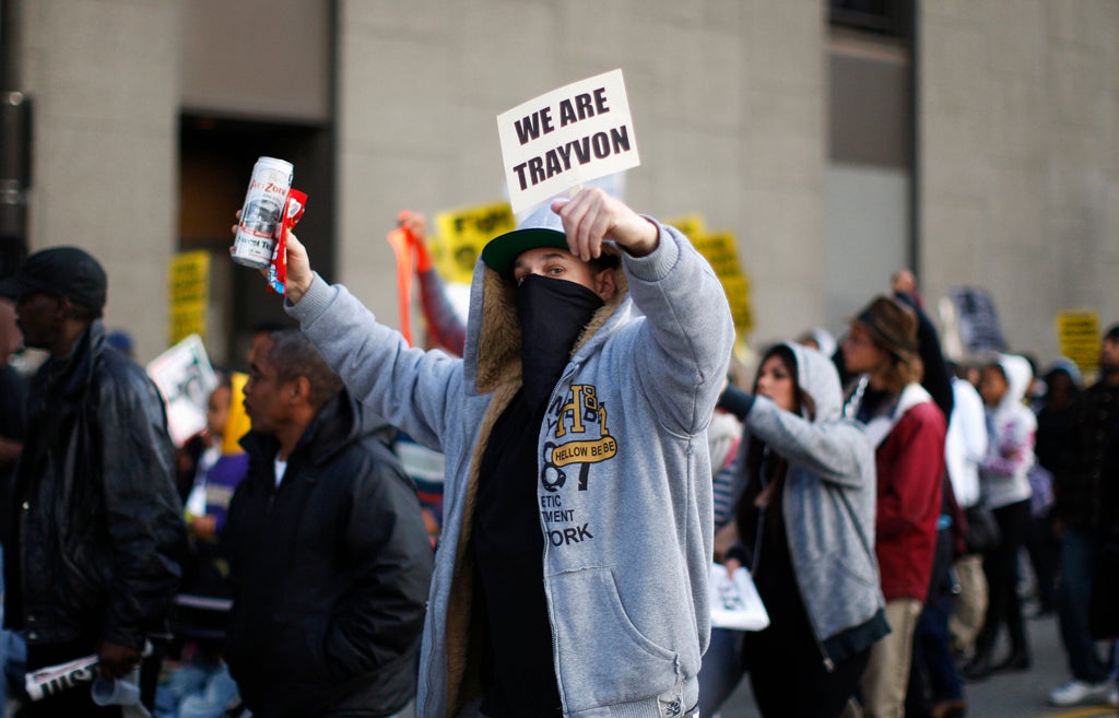 People chants slogans as they participate in a Million Hoodies March, to protest the failure of police to arrest a Florida neighborhood watch volunteer for shooting to death an unarmed black teenager, Trayvon Martin, in Los Angeles, California, March 26, 2012.