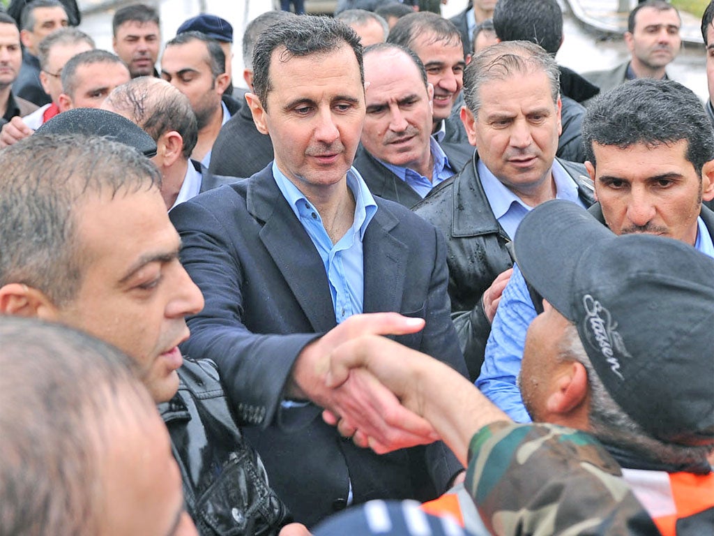 Syria's President Bashar al-Assad touring the devastated Baba Amr neighbourhood of Homs yesterday
