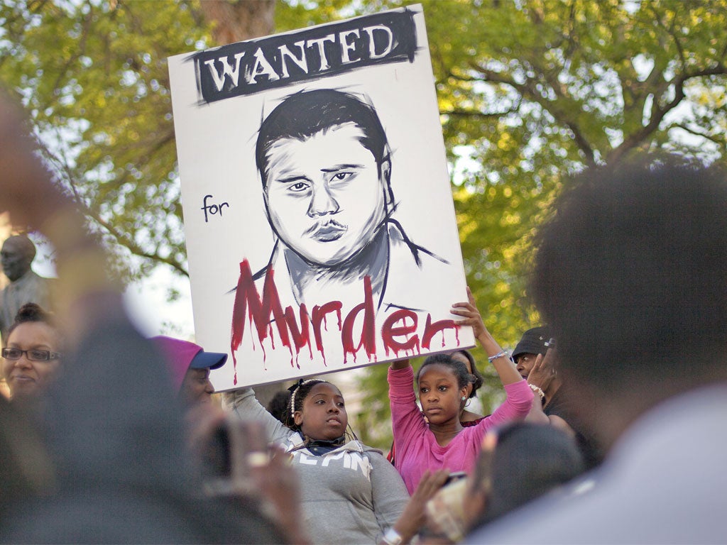 Protesters in Atlanta with a poster of George Zimmerman, who shot and killed Trayvon Martin
