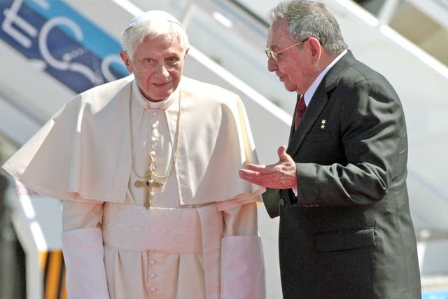 Pope Benedict XVI is greeted by President Raul Castro after flying in to Santiago de Cuba's airport