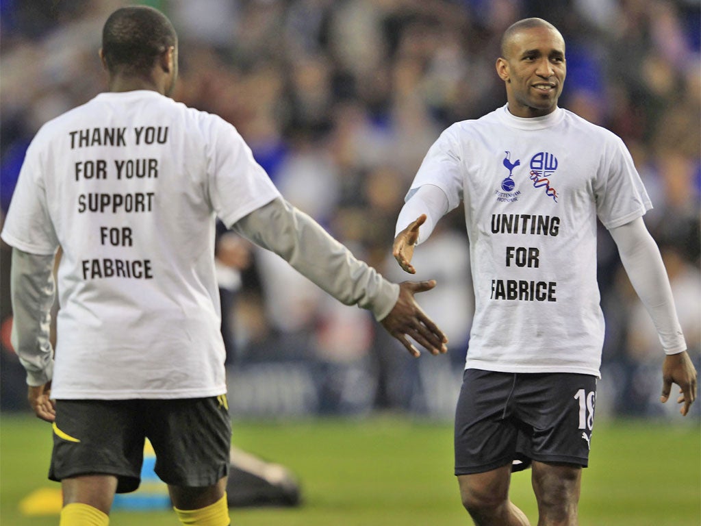 Bolton's Nigel Reo-Coker (left) and Tottenham's Jermain Defoe show their support