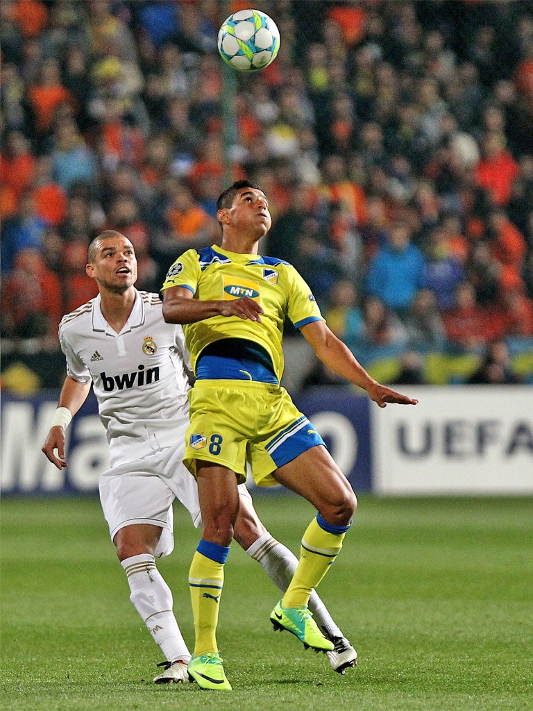 Apoel's Ailton (right) and Madrid's Pepe compete for the ball