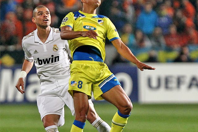 Apoel's Ailton (right) and Madrid's Pepe compete for the ball