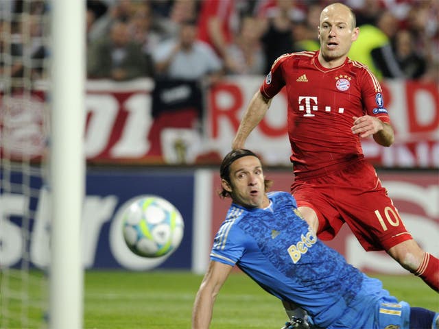 Arjen Robben watches the ball as he scores Bayern's second