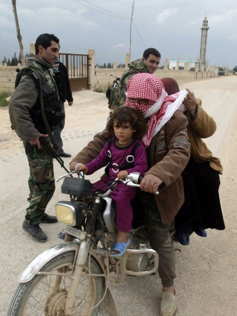A family fleeing the violence in Syria arrives at a Lebanese army checkpoint
