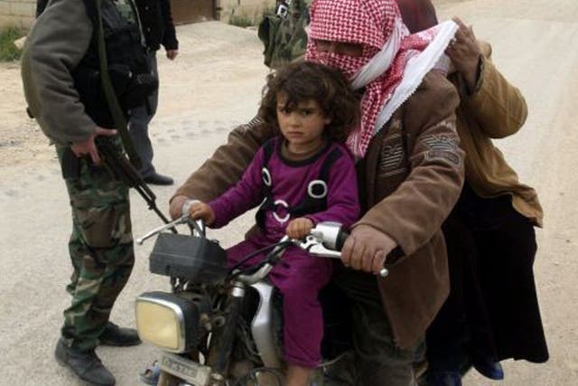 A family fleeing the violence in Syria arrives at a Lebanese army checkpoint