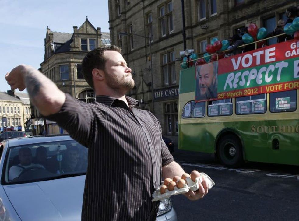 The protester throws eggs prior to George Galloway's victory parade in Bradford