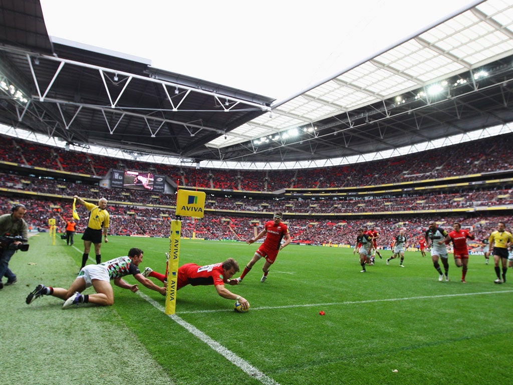 Touch And Go: Saracens' Chris Wyles is tackled into touch by George Lowe of Harlequins at Wembley