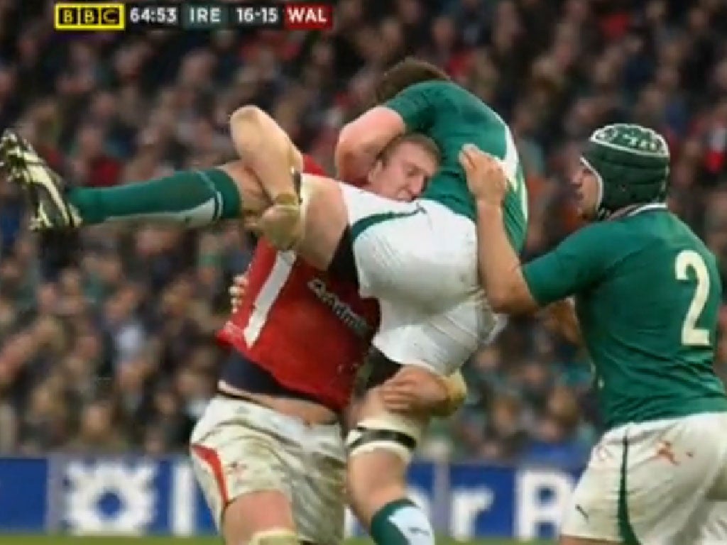 Not so grand slam: Bradley Davies inflicts the 'tip' tackle on Ireland's Donnacha Ryan that saw him banned for seven weeks