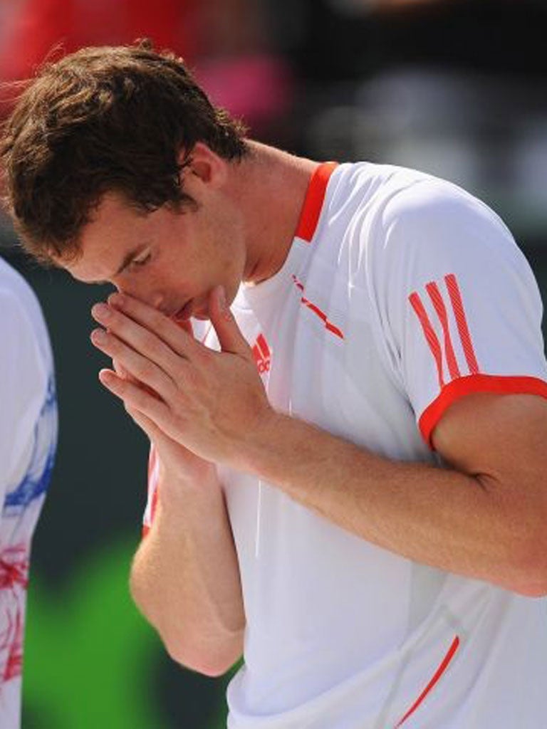 Andy Murray looks dejected after his 6-1, 7-6 defeat to Djokovic