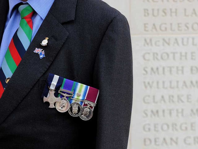 Falklands veteran John Phillips, a former Bomb disposal officer, displays his medals at the National Memorial Arboretum in Staffordshire today