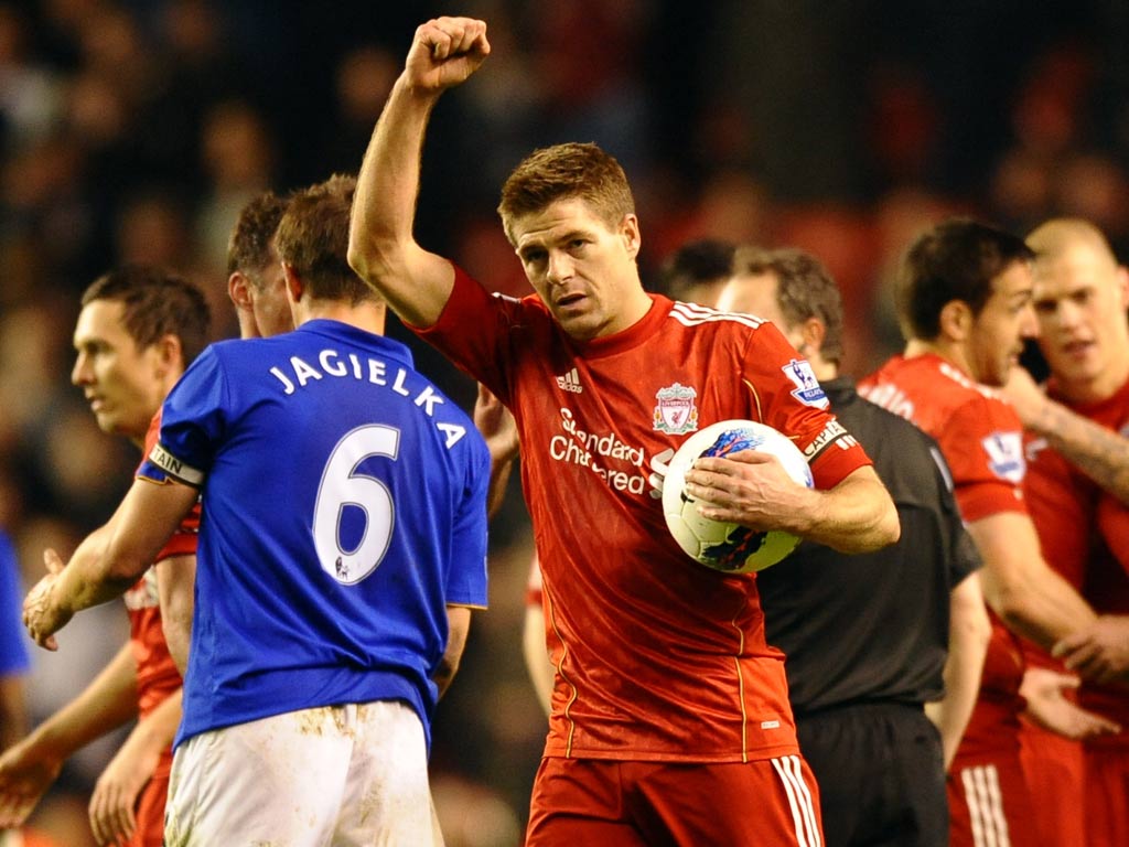 Gerrard holds the match ball after his hat-trick in March 2012