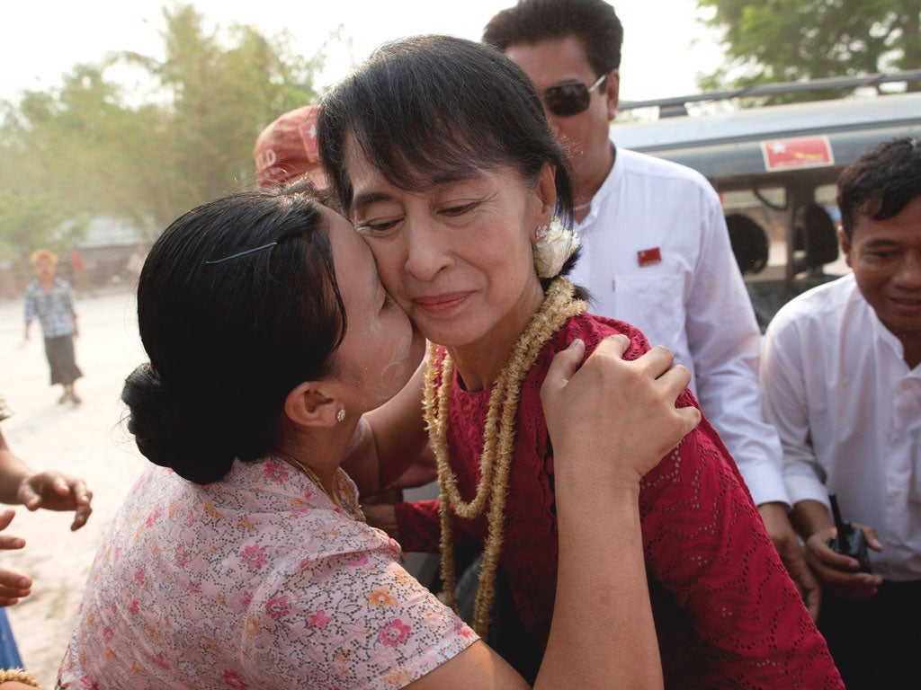 A supporter kisses Aung San Suu Kyi, leader of the National League for Democracy, as she visits polling stations in her constituency as Burmese vote in the parliamentary elections on April 1