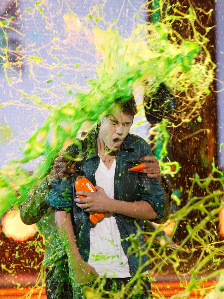 Singer Justin Bieber is slimed on stage at Nickelodeon's 25th annual Kids' Choice Awards in LA