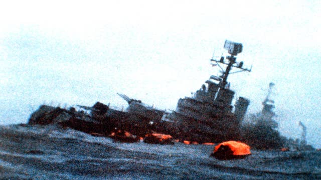 The Belgrano sinks amid orange life rafts holding
survivors in the South Atlantic in May 1982