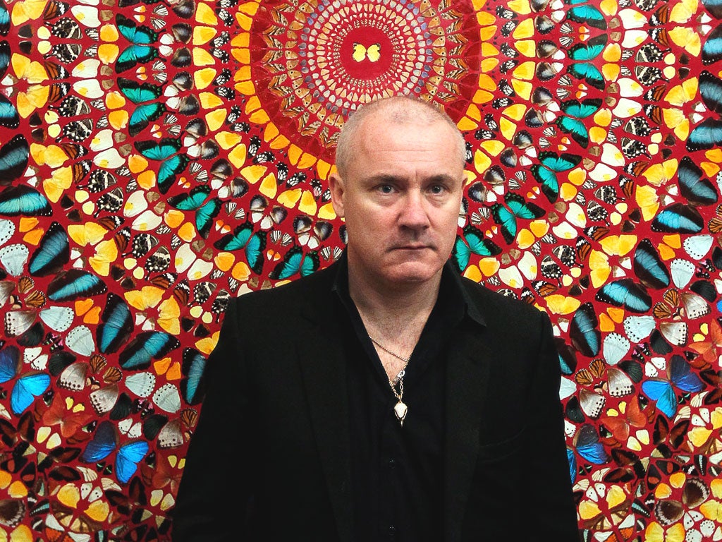 Damien Hirst poses in front of his work, I Am Become Death, Shatterer of Worlds, at the retrospective show at
the Tate Modern which opens tomorrow