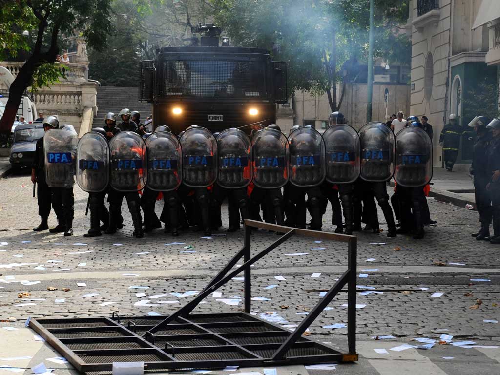 Riot police gather to confront demonstrators near the British embassy in Buenos Aires