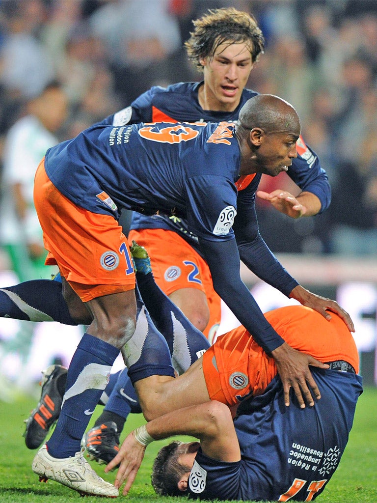 Montpellier's Olivier Giroud (bottom) takes a tumble after scoring against St Etienne