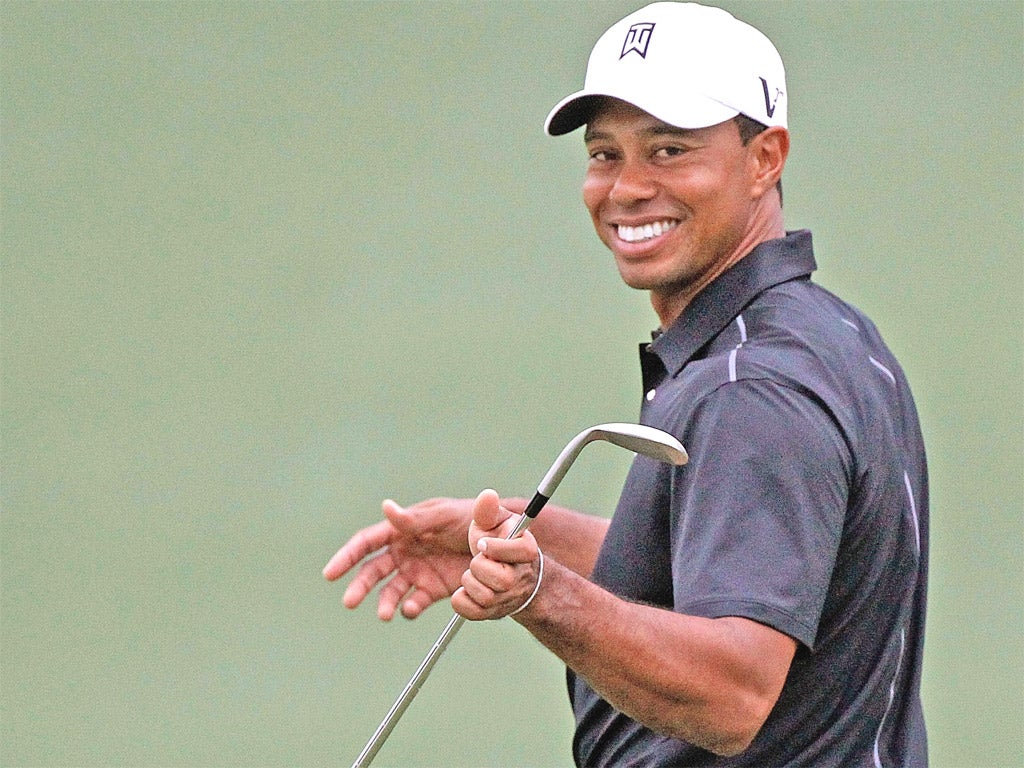 Tiger Woods is all smiles during practice at Augusta yesterday