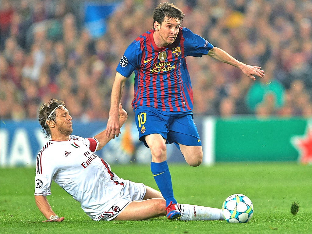 Lionel Messi leaves the Milan captain Massimo Ambrosini trailing