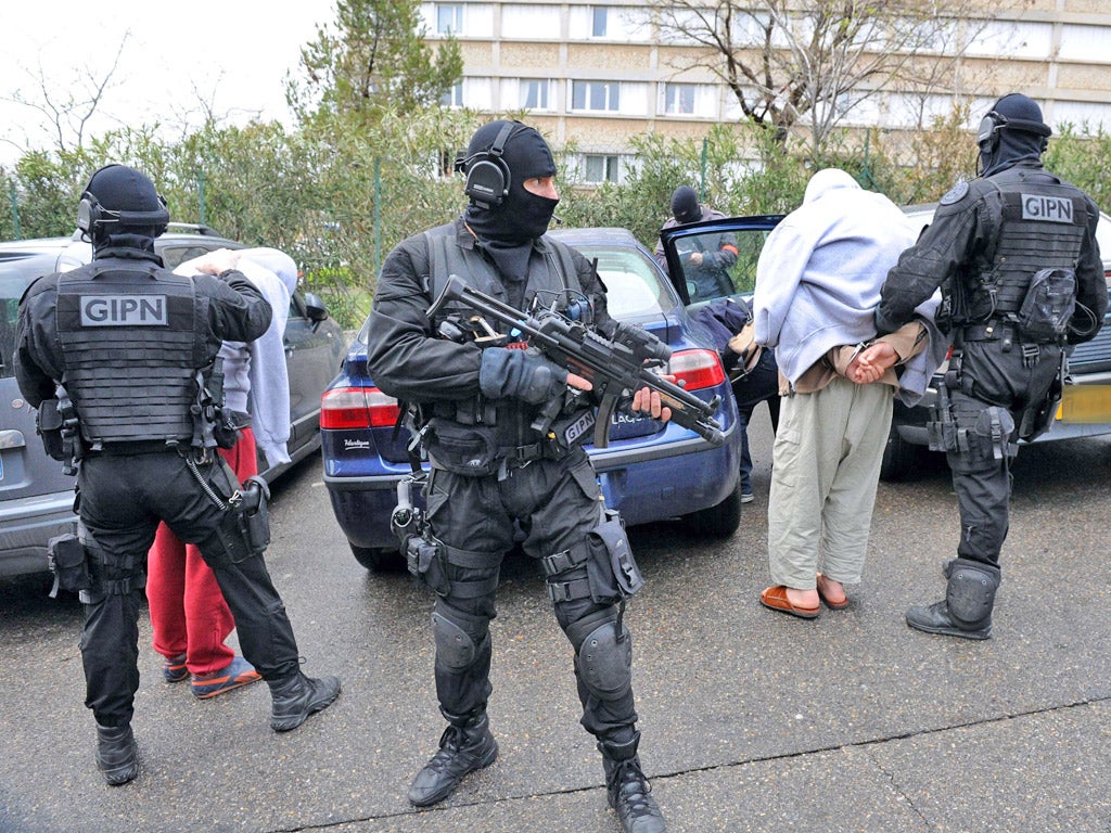 French members of the French National Police Intervention Group (GIPN) arrest suspected radical Islamists