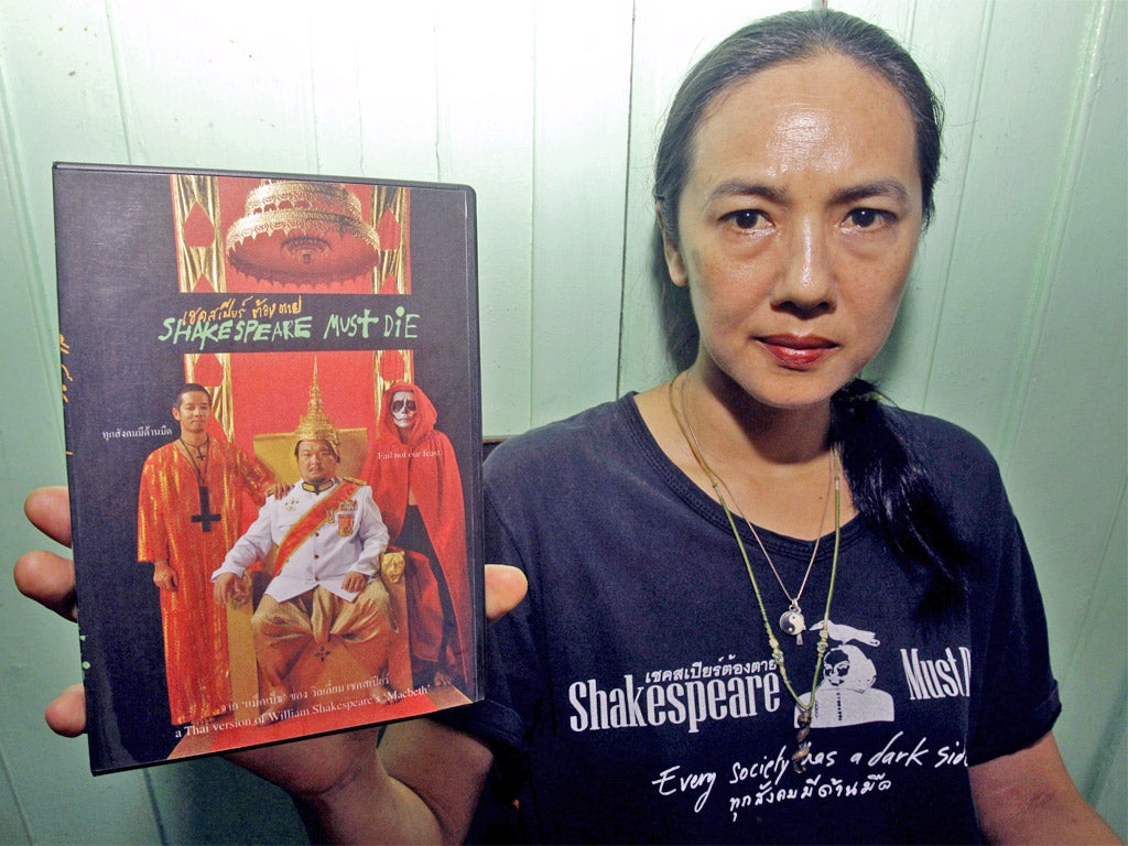 Director of 'Shakespeare Must Die' Ing Kanjanavanit holds up a DVD the banned movie