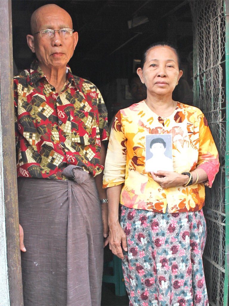 U Thaung Sein and Daw San Myint with a picture of their jailed son, Ko Aye Aung